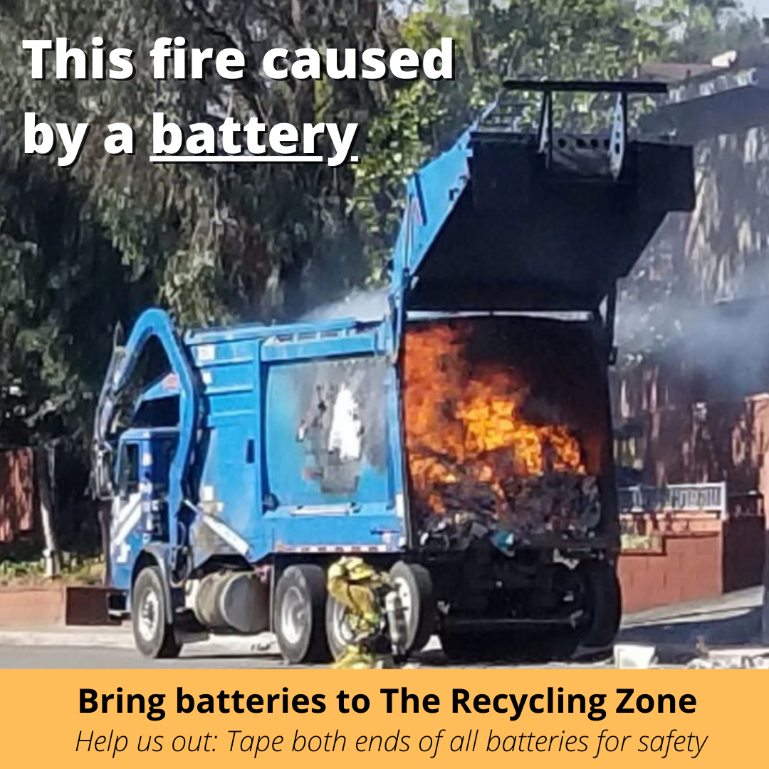 Waste collection truck with flames shooting out of back; text "This fire caused by a battery, bring batteries to The Recycling Zone"