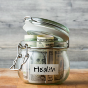 Jar with money in it with tape label reading "Health"