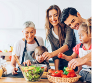 Family making a salad with red peppers, lettuce