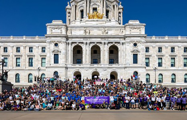 Large group of people gathered at the Minnesota State Capitol in celebration of Recovery Month