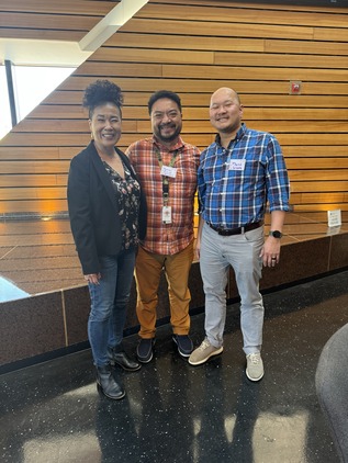 Three AAPI people smiling at a conference for AAPI leaders.