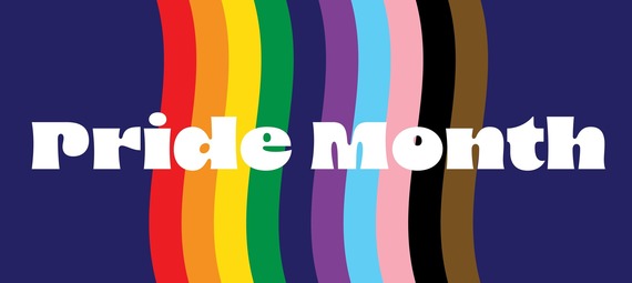 Pride Month in white text over a navy background, with a rainbow in the colors of the LGBTQIA2S+ Pride Flag.
