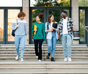 Group of four students walking down steps.