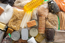 Collection of canned and packaged food on a table.