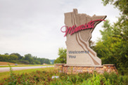 Minnesota welcome sign along the side of the road.