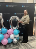 Nekey Oliver holding an award.