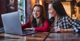 Two people at a computer.