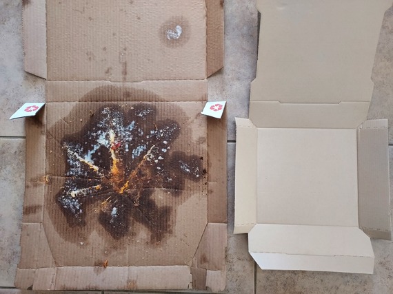 A soiled pizza box next to a clean pizza box. 