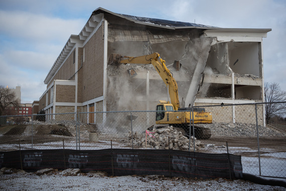 Excavator demolishes wall of YMCA building