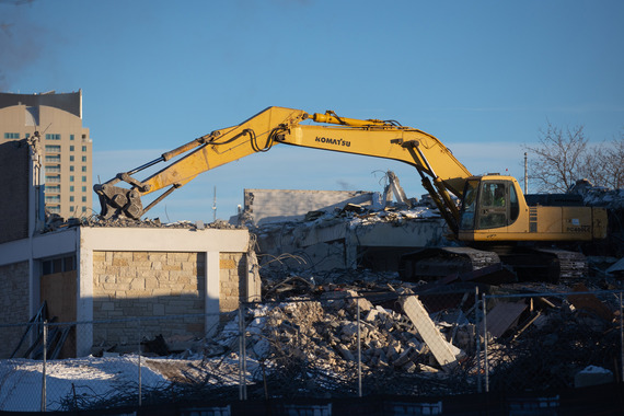 An excavator continues work on the YMCA deconstruction project