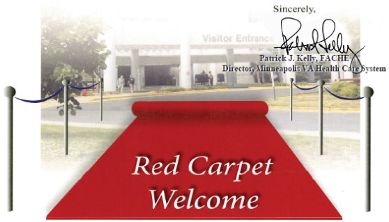 Picture of a red carpet being laid out to welcome veterans