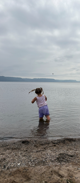 Picture of Tiffany's daughter throwing a rock into Lake Pepin