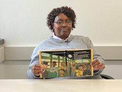 Bus Operator Margaret Stephens reading "I Am Rosa Parks."