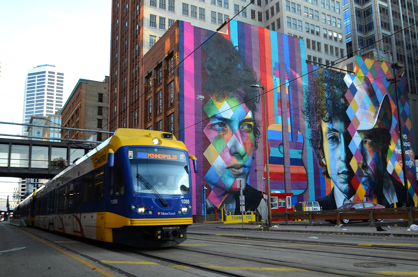 Giant mural of Bob Dylan with LRT train in downtown Minneapolis.