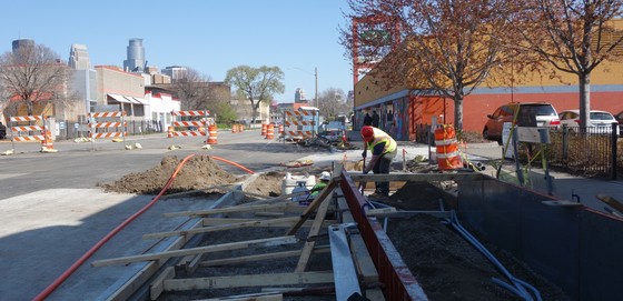 a worker prepares curb and gutter for a concrete pour at Chicago Avenue and Franklin Avenue