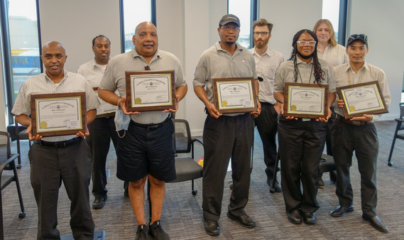 Bus operators with their certificates.