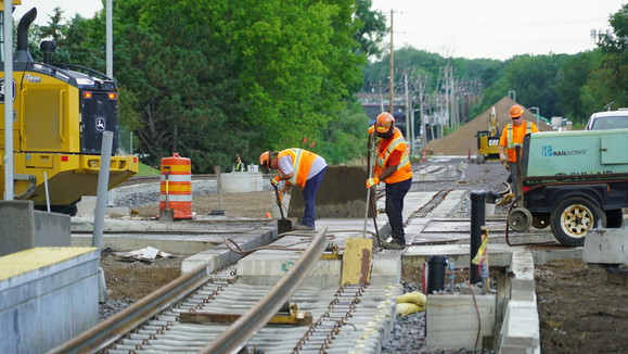 View of workers preparing tracks near the Downtown Hopkins Station