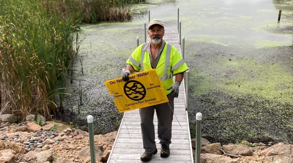 Interceptor Services employee Mike Rosenberger removes signs at Seton Lake