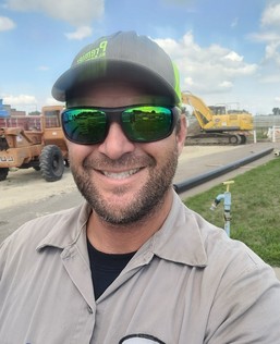Plant operator, Ryan Zajac, smiling while on-the-job.