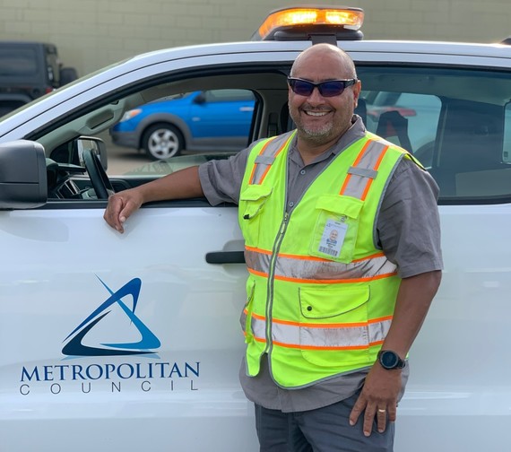Interceptor service worker, Gabe Rios, poses in front of his work truck.
