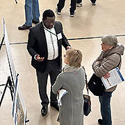 People talking at Blue Line Extension project open house.
