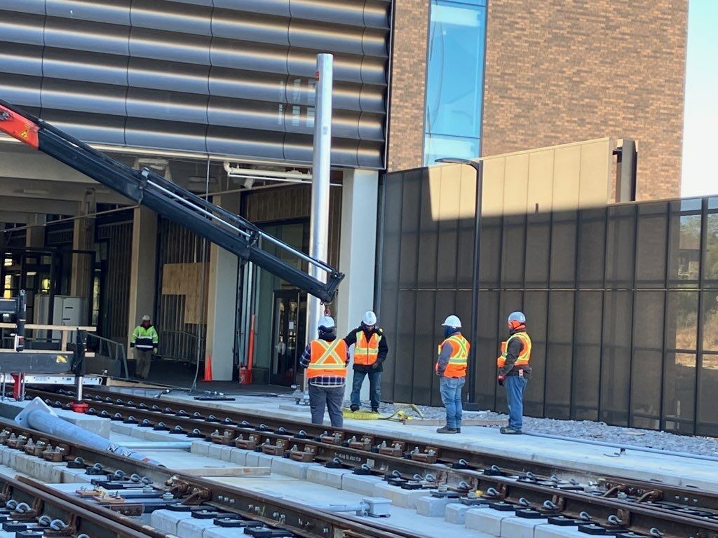 Workers installing metal pole