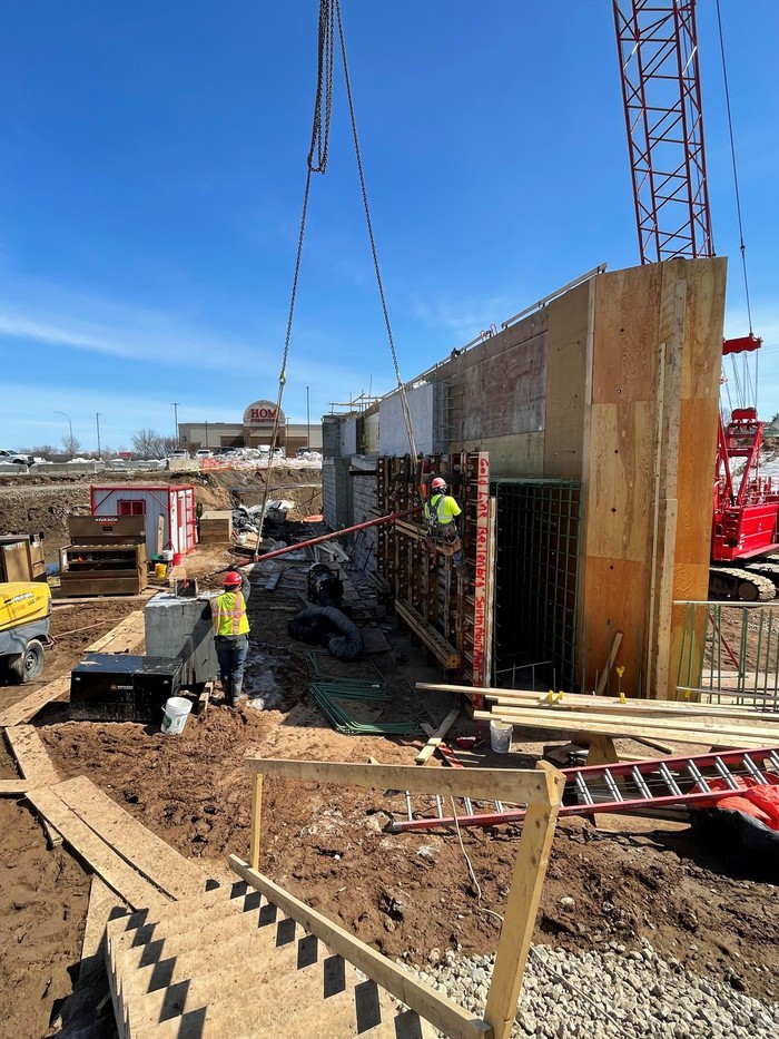 Crews constructing forms for a bridge abutment 