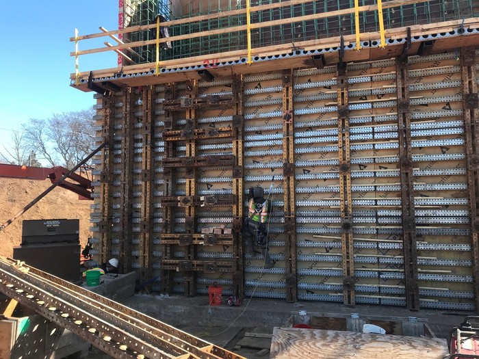 Crews setting forms for bridge abutment