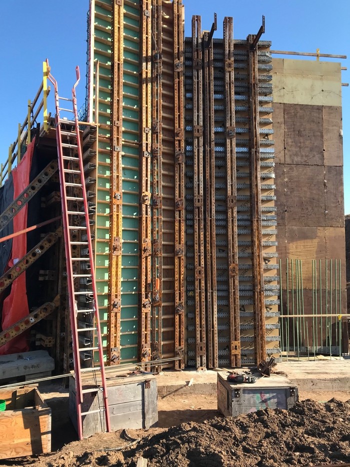 Crews setting forms for bridge abutment