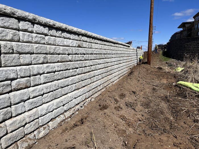 Crews build retaining wall near Tamarack Road in Woodbury. 