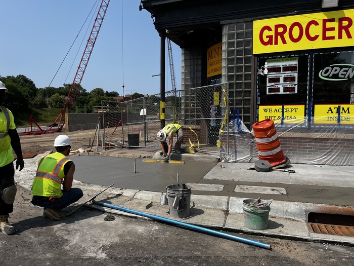 Crews pour sidewalks at Earl Street in East St. Paul