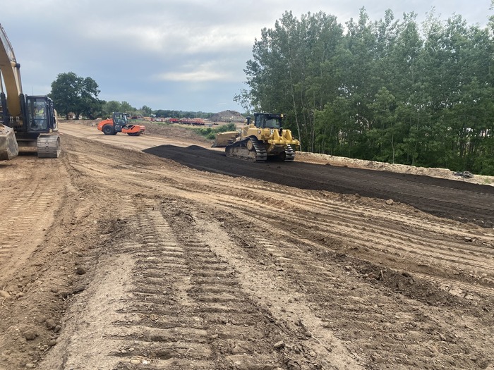 Crews work in Oakdale constructing road foundations for the future bus guideway