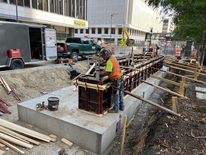 Crews build station platform foundations at 5th St and Cedar St in Downtown St. Paul