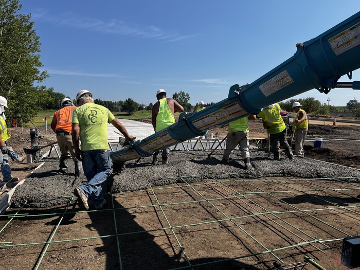 Crews pour concrete for bus-only lanes in Oakdale