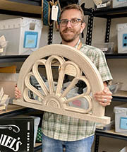 Man shows architectural ornament left on a bus
