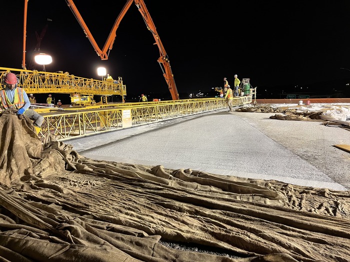 Crews pour concrete for the bridge decking on the new Bielenberg Drive bridge