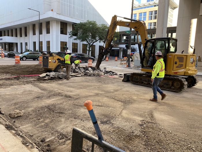 Crews remove pavement at 5th Street and Minnesota in Downtown St. Paul