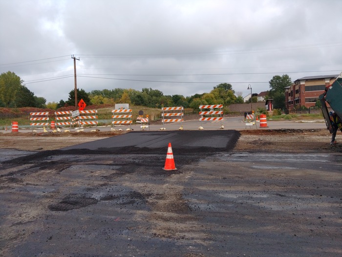 Crews pave temporary driveway access at Tamarack Hills in Woodbury