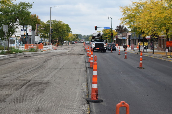 A view of Lake Street looking east at 35th Avenue. Half of the road is repaved, half is milled