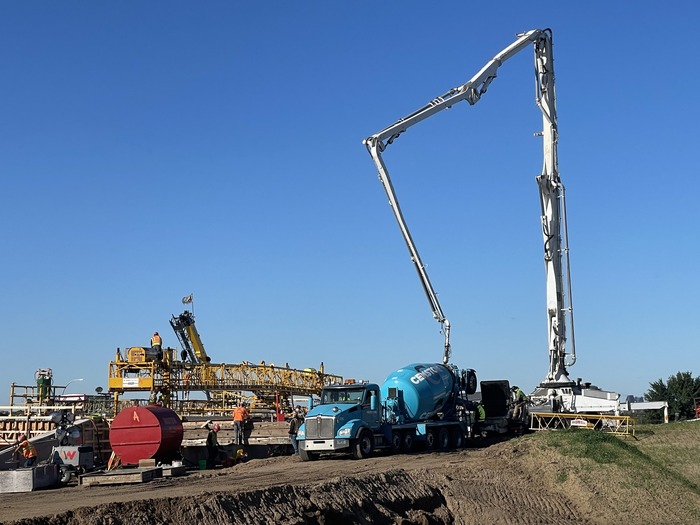 Crews pour concrete for a new section of the Ruth Street bridge in East St. Paul