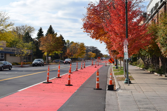 An image showing a freshly painted red bus lane on Lake Street