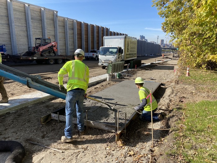 Crews pour sidewalks on Hudson Road in East St. Paul. 