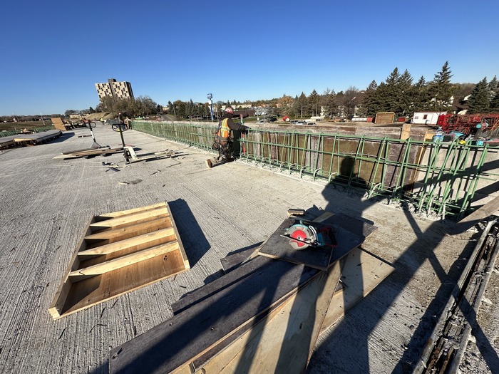 Crews construct bridge barriers on the Etna Street bridge in East St. Paul