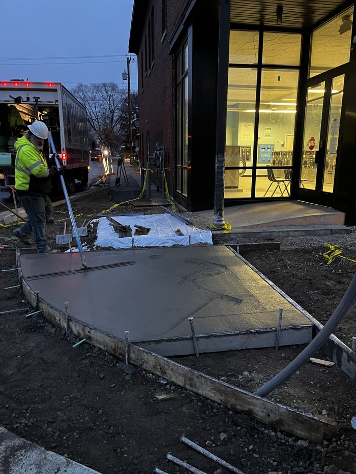 Crews pour concrete for sidewalks along Hudson Road. 