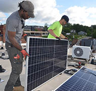 Workers installing solar panels