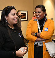 Two women from Mi C.A.S.A. talking together.