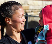 Woman smiling at baby near Mississippi River.