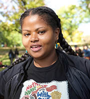 Woman in t-shirt that says, "Nothing about us without us is for us."