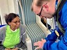 Transit agent talks with woman on train