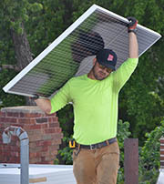 Man carrying solar panel